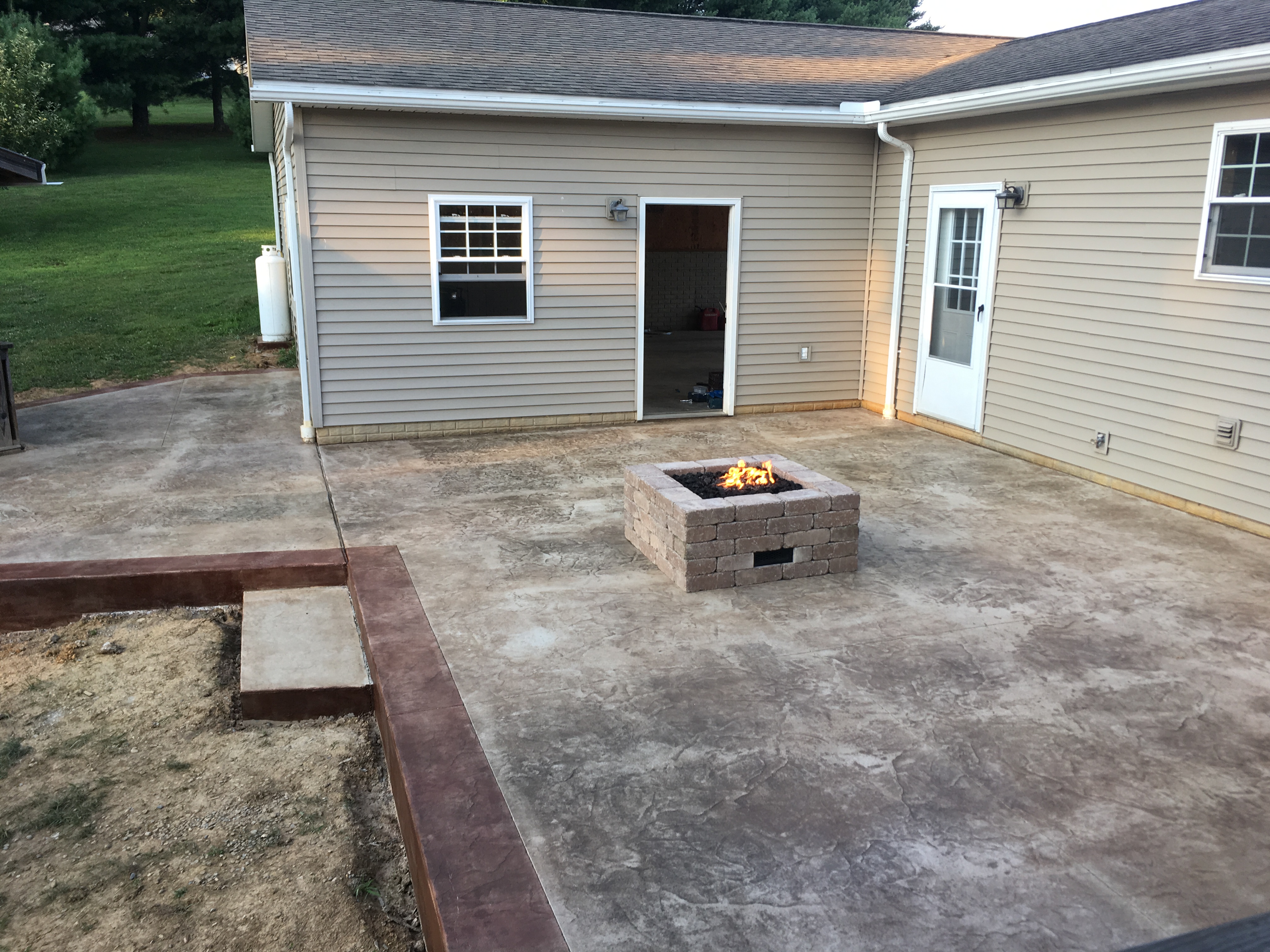 concrete patio with fireplace